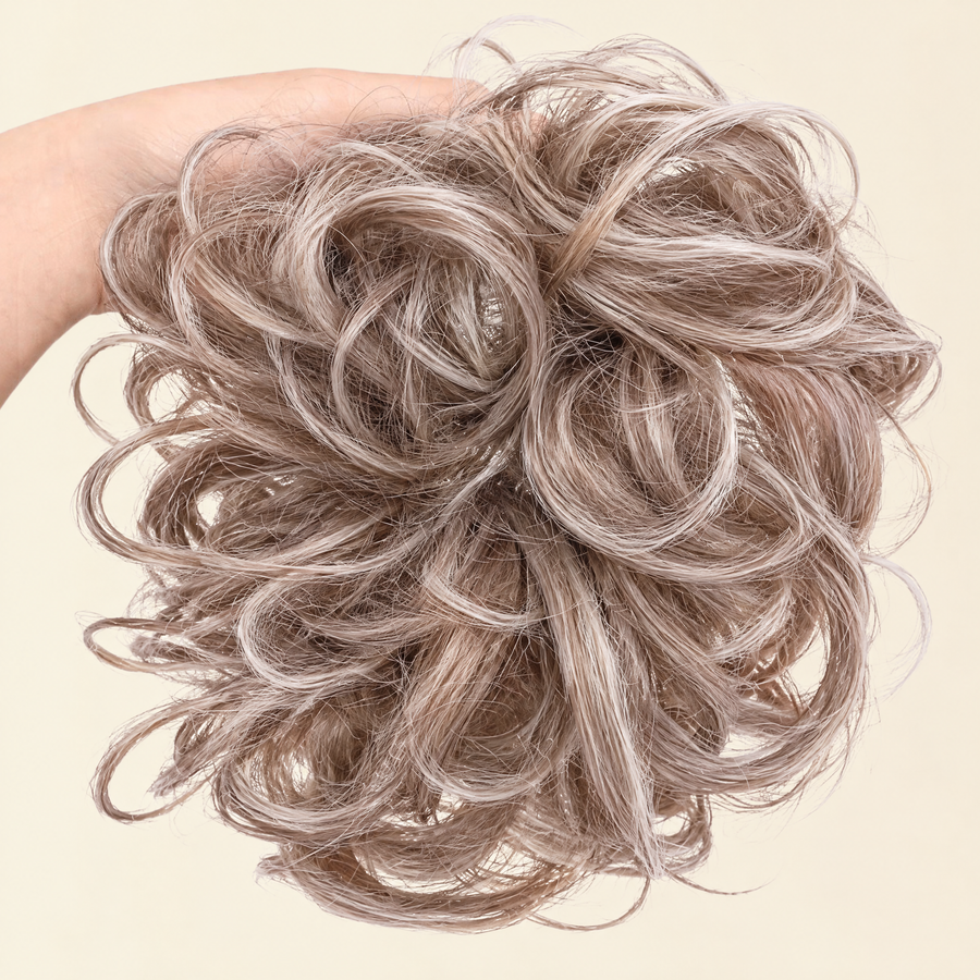Hand holding the full JuvaBun Messy Bun in Beach Blonde