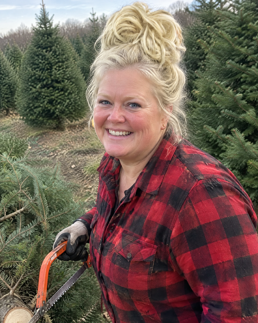 Woman wearing the JuvaBun Messy Bun in Pure Blonde at a Christmas tree farm