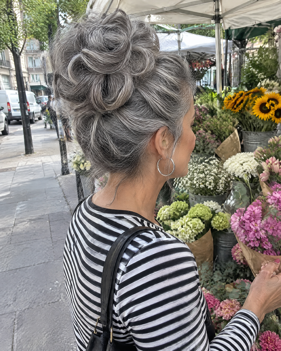 Woman wearing the JuvaBun Messy Bun in Salt And Pepper at the flower market