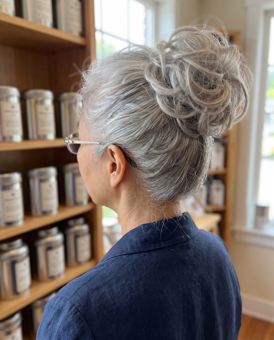 Woman wearing the JuvaBun Messy Bun in Silver Gray at a tea shop