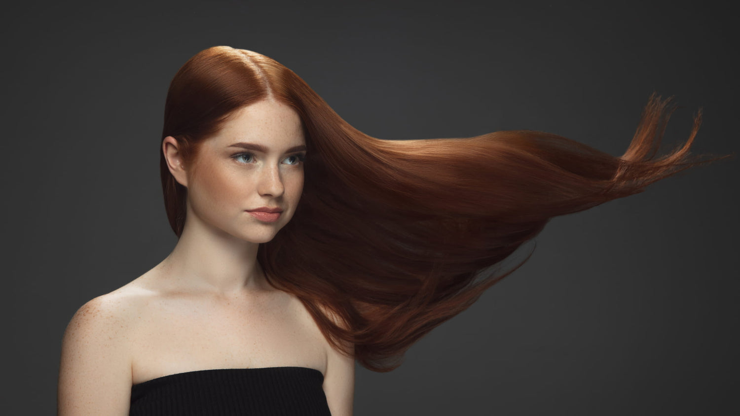 woman with her hair being blown by the air