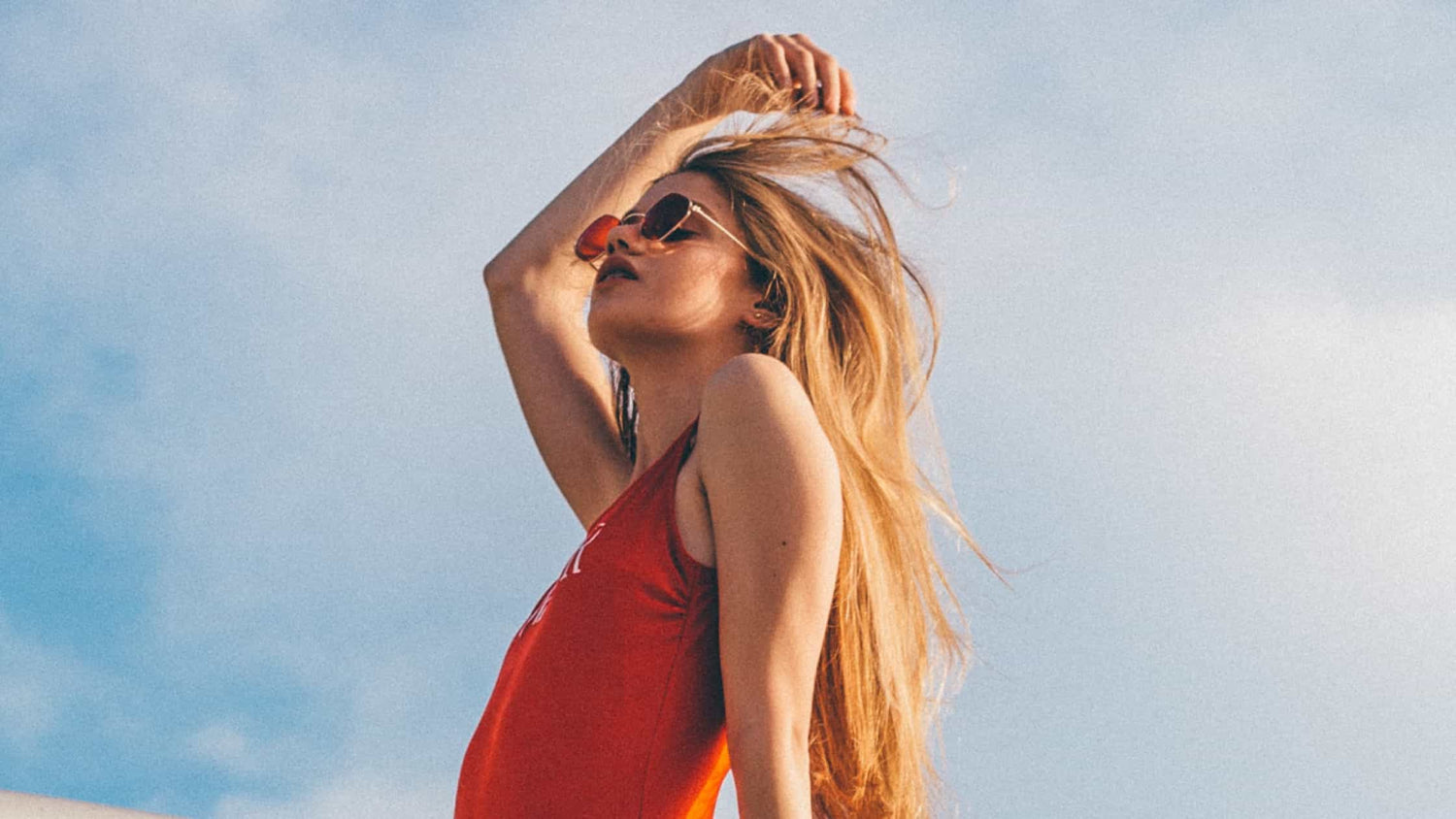 woman basking her hair in the summer heat