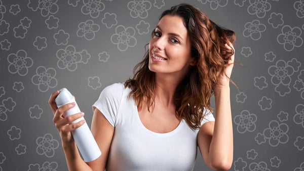 Woman about to spray on her hair
