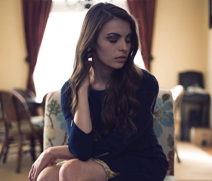 woman with wavy hair sitting on a chair