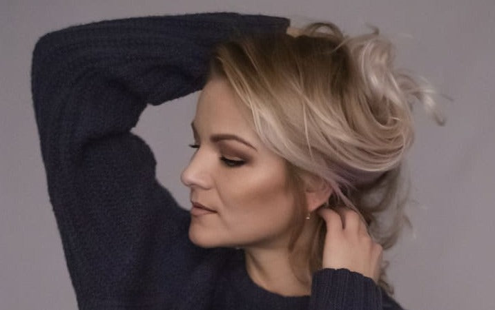 woman styling her blonde hair