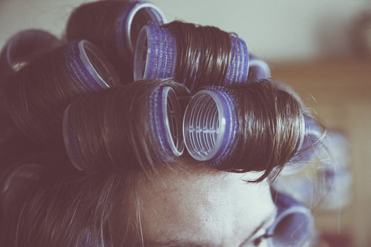 woman curling her hair extensions