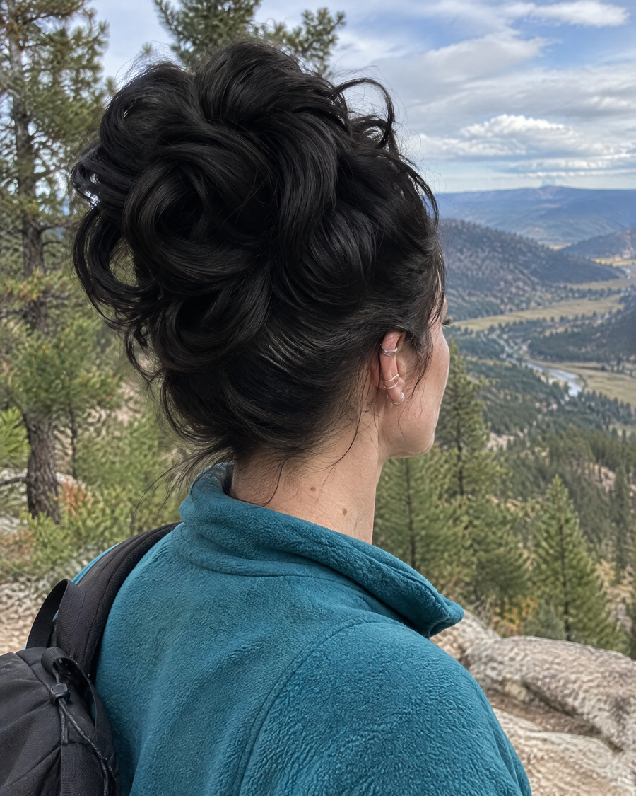 Woman wearing the JuvaBun Messy Bun in Black at a hiking trail overlook