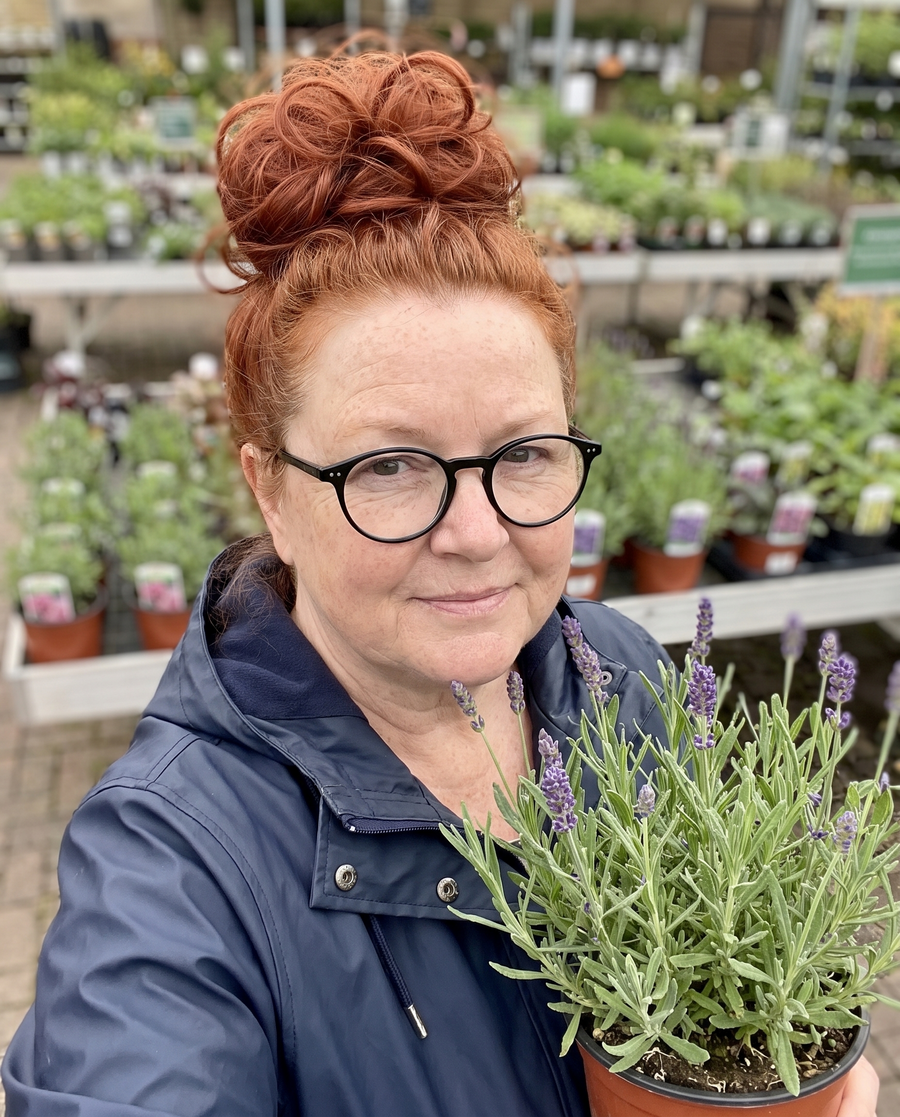 Woman wearing the JuvaBun Messy Bun in Copper Red at a garden center