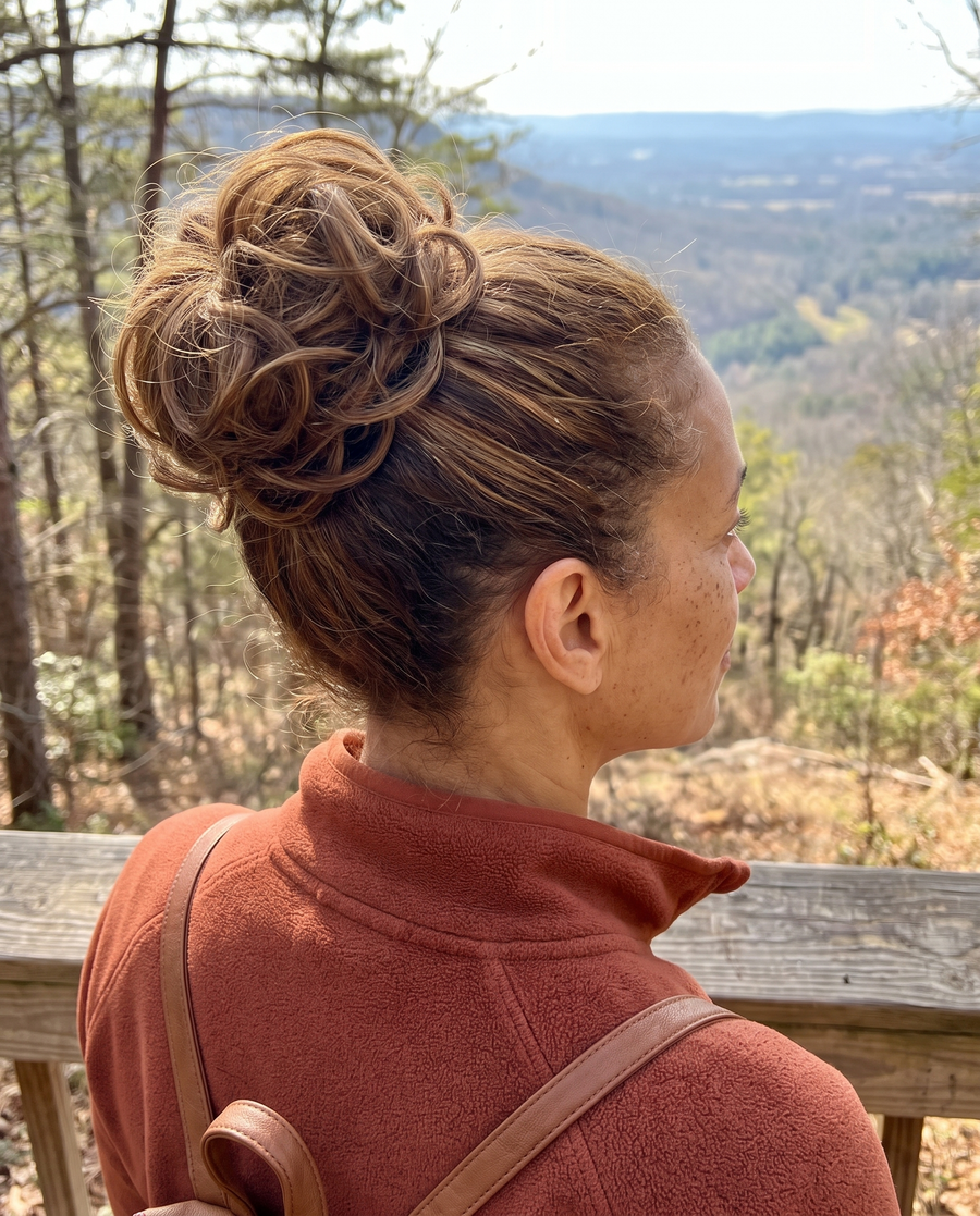 Woman wearing the JuvaBun Messy Bun in Light Brown on a hiking trail