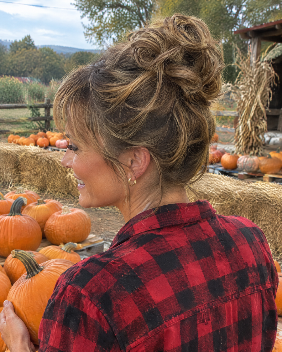Woman wearing the JuvaBun Messy Bun in Light Brown at a pumpkin patch