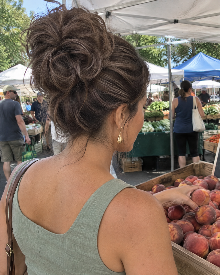 Woman wearing the JuvaBun Messy Bun in Medium Brown at the farmers market