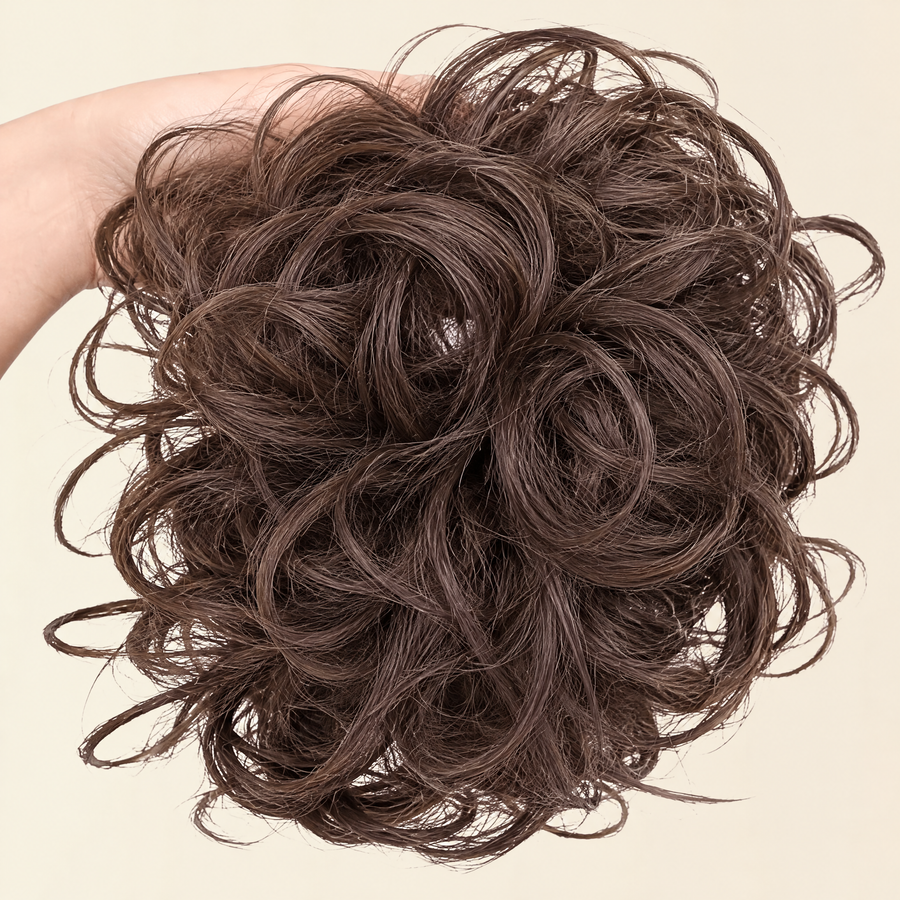 Hand holding the full JuvaBun Messy Bun in Medium Brown