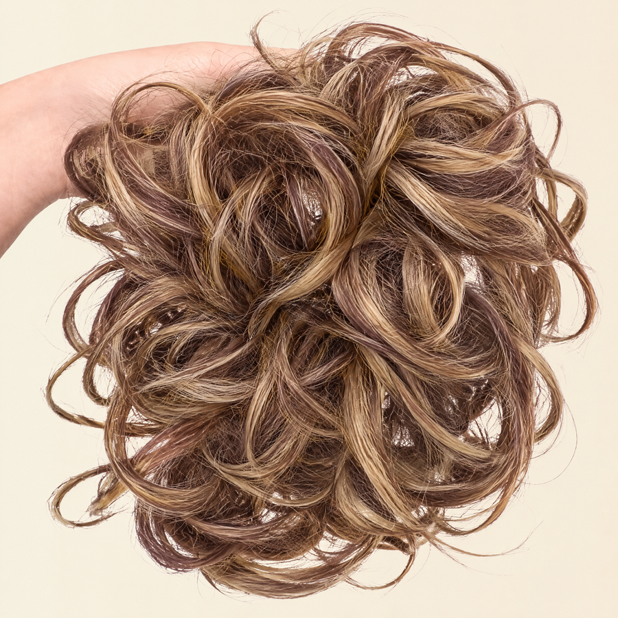 Hand holding the full JuvaBun Messy Bun in Mix Walnut