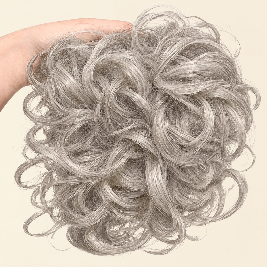 Hand holding the full JuvaBun Messy Bun in Silver Gray